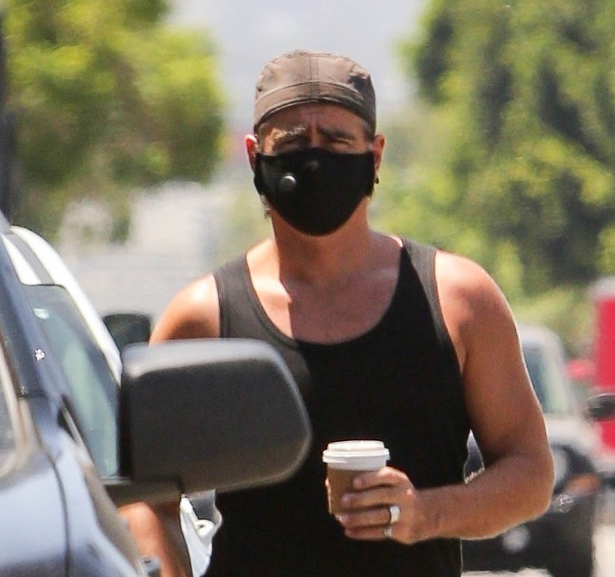 Colin Farrell: tank top, masks, and books