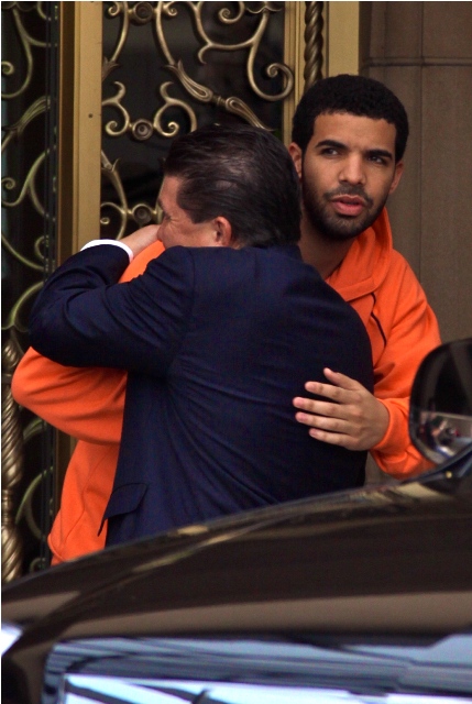 Drake man-hugs, will host