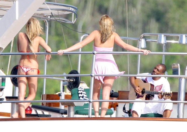 Gay with a guitar on a boat