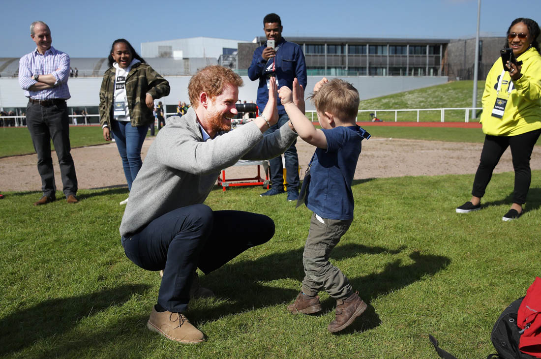 Prince Harry with babies and dogs